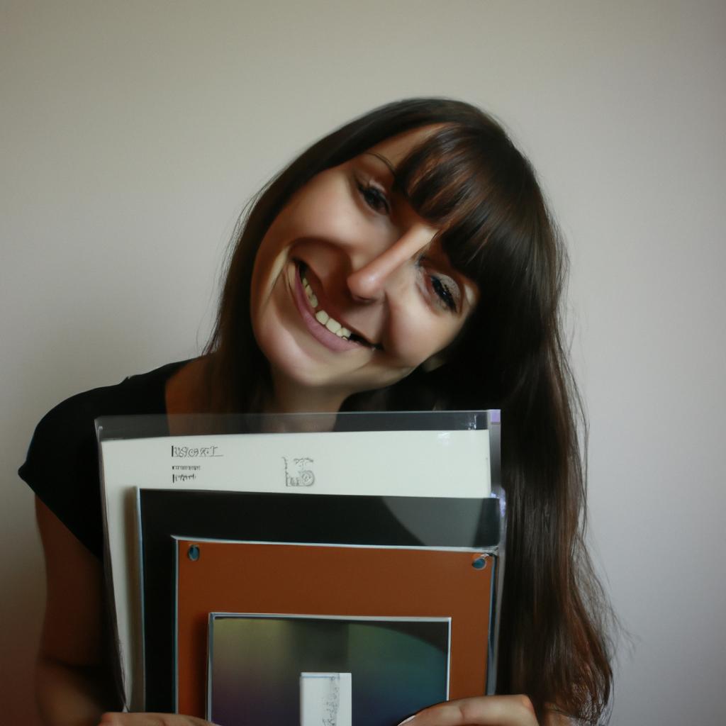 Person holding music albums, smiling